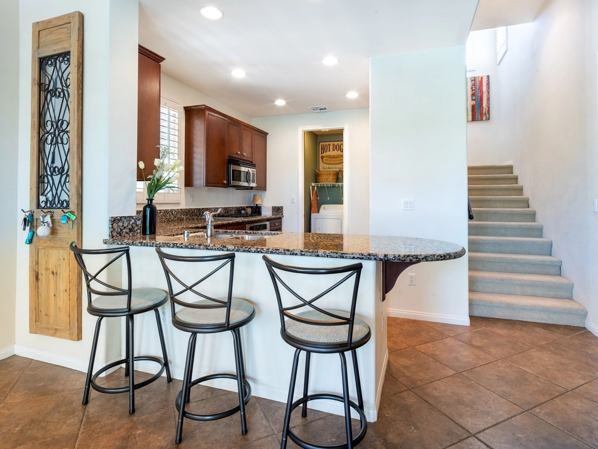 Modern kitchen with granite countertop and bar stools